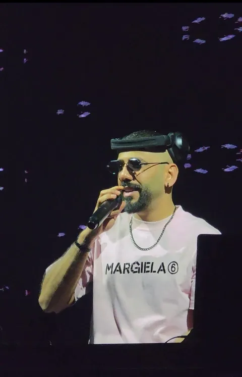 A performer singing into a microphone on stage at XO Club Dubai