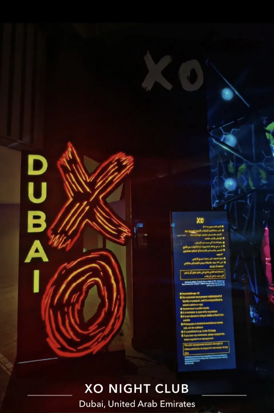 The red and yellow neon XO Dubai sign inside XO Club Dubai